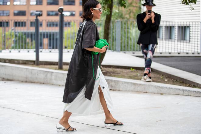 COPENHAGEN, DENMARK - AUGUST 06: Desirée Kastull is seen wearing green bag, white dress, brown coat outside Brøgger during Copenhagen Fashion Week Spring/Summer 2020 on August 06, 2019 in Copenhagen, Denmark. (Photo by Christian Vierig/Getty Images)