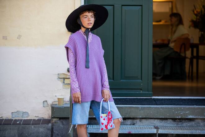 COPENHAGEN, DENMARK - AUGUST 11: A guest is seen wearing hat, purple Keiko vest 11250, denim shorts outside Samsøe & Samsøe during Copenhagen Fashion Week Spring/Summer 2021 on August 11, 2020 in Copenhagen, Denmark. (Photo by Christian Vierig/Getty Images)