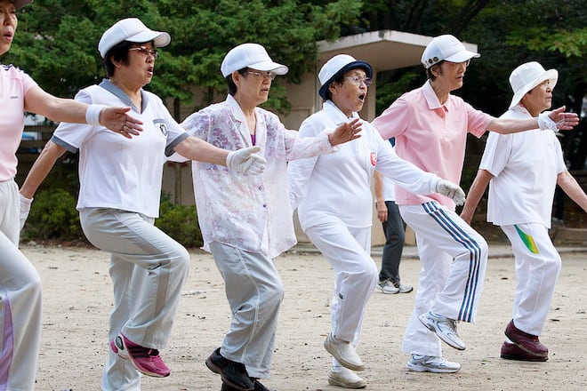 People exercise to the NHK morning radio calisthenics broadcast at a park in Tokyo, Japan, on Thursday, Sept. 6, 2012. Within four decades, almost half the people in the world's third-largest economy will be 65 years or older, compared with one in four now. Photographer: Tomohiro Ohsumi/Bloomberg via Getty Images
