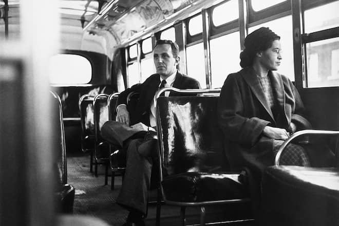 Rosa Parks sits in the front of a bus in Montgomery, Alabama, after the Supreme Court ruled segregation illegal on the city bus system on December 21st, 1956. Parks was arrested on December 1, 1955 for refusing to give up her seat in the front of a bus in Montgomery set off a successful boycott of the city busses. Man sitting behind Parks is Nicholas C. Chriss, a reporter for United Press International out of Atlanta.