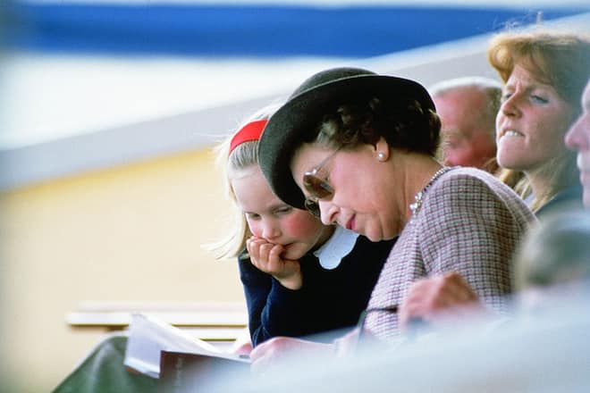 WINDSOR, UNITED KINGDOM - MAY 24: Queen Elizabeth II reading with her granddaugter Zara Phillips at Windsor Horse Show. (Photo by Tim Graham Photo Library via Getty Images)