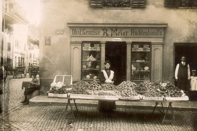 an old photograph of a woman on a market stall