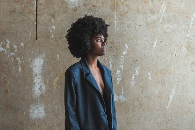 a woman with afro in a black blazer