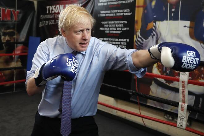 FILE - In this Tuesday, Nov. 19, 2019 file photo Britain's Prime Minister Boris Johnson poses for a photo wearing boxing gloves during a stop in his General Election Campaign trail at Jimmy Egan's Boxing Academy in Manchester, England. (AP Photo/Frank Augstein, File)
