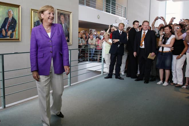 BERLIN - AUGUST 23: German Chancellor Angela Merkel welcomes visitors at an open house day at the Chancellery on August 23, 2009 in Berlin, Germany. Thousands of visitors had come to visit during the German Government's annual open house day. (Photo by Andreas Rentz/Getty Images)