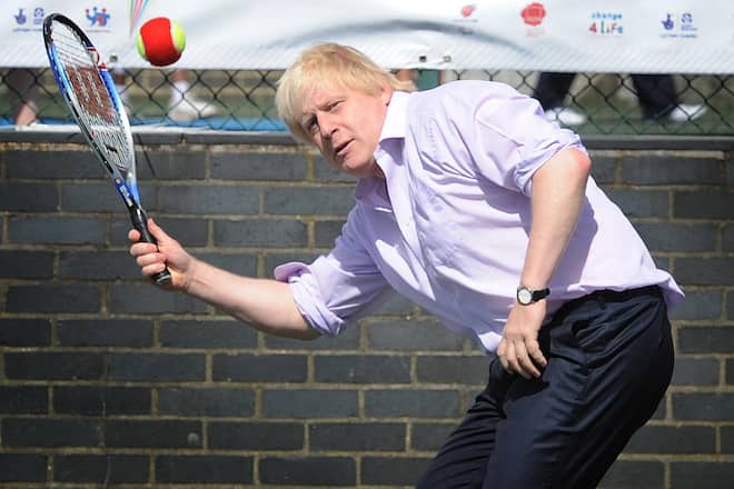 Mayor of London Boris Johnson plays tennis against school children at the London School Games Festival in Crystal Palace, south London. (Photo by Stefan Rousseau/PA Images via Getty Images)