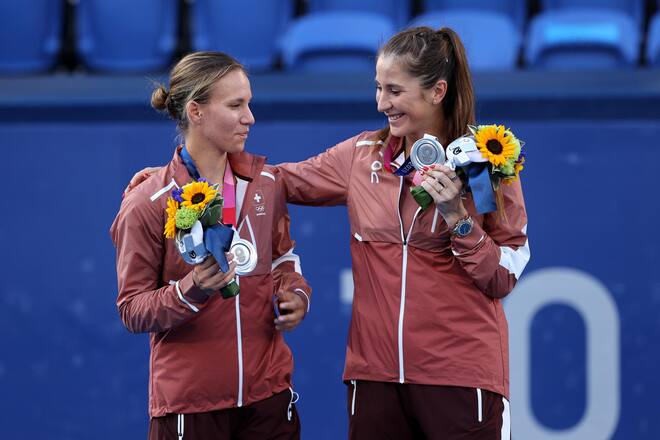 TOKYO, JAPAN - AUGUST 01: (L-R) Silver Medalists Viktorija Golubic of Team Switzerland and Belinda Bencic of Team Switzerland pose on the podium during the medal ceremony for Tennis Women's Doubles on day nine of the Tokyo 2020 Olympic Games at Ariake Tennis Park on August 01, 2021 in Tokyo, Japan. (Photo by Clive Brunskill/Getty Images)