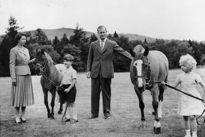 16th September 1955: From left to right: Queen Elizabeth II; Prince Charles (later Prince of Wales); Prince Philip, Duke of Edinburgh and Princess Anne (later Princess Royal) with two ponies in the grounds of Balmoral Castle, Scotland. (Photo by Central Press/Getty Images)
