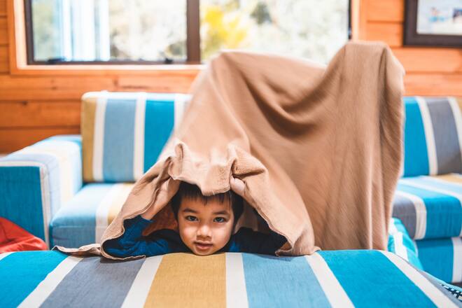 Playful kid enjoying day at home playing and getting most out of it.
