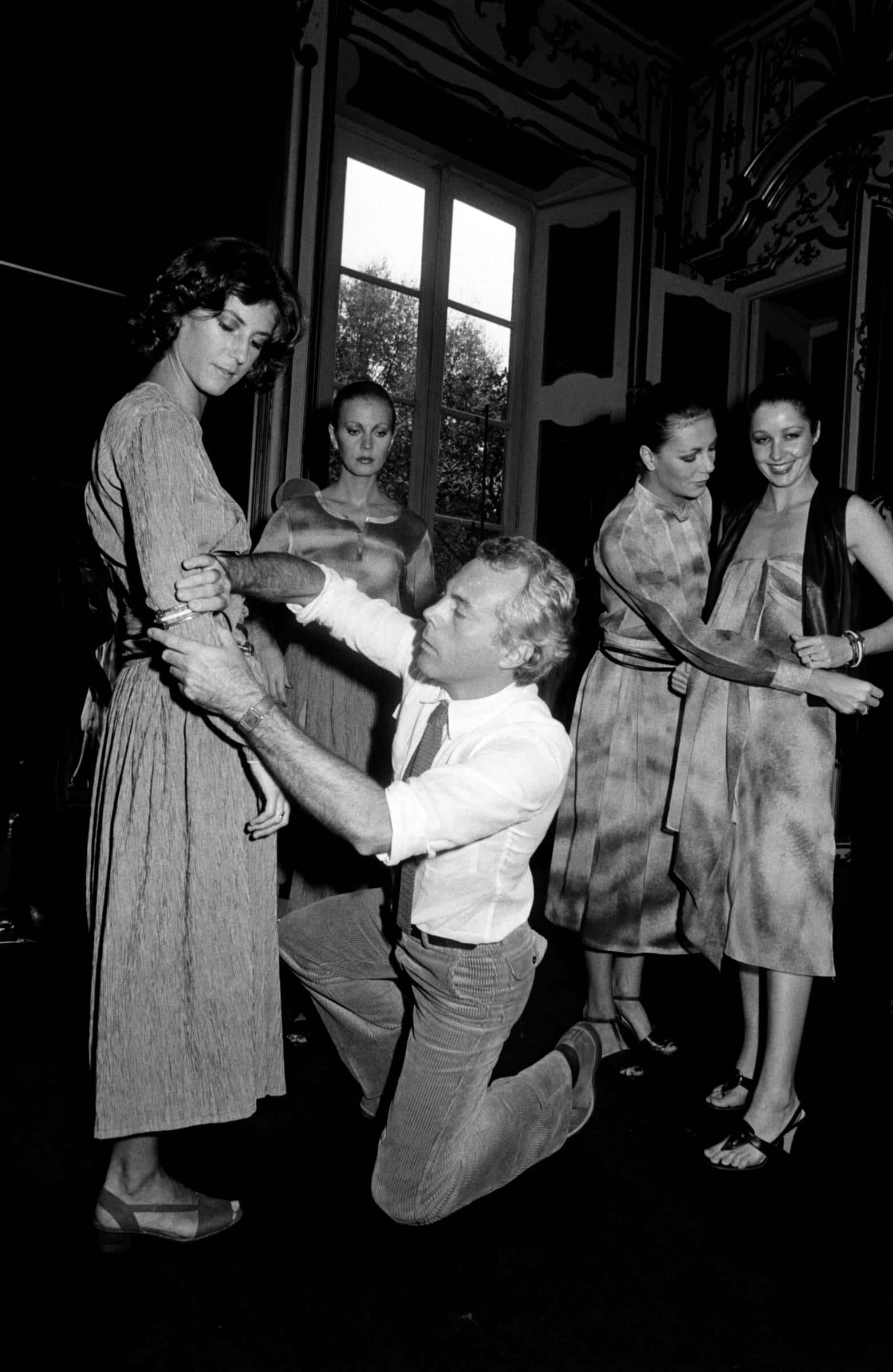 Designer Giorgio Armani Adjusts Models for Giorgio Armani Spring 1978 Ready to Wear Advance (Photo by Tim Jenkins/WWD/Penske Media via Getty Images)